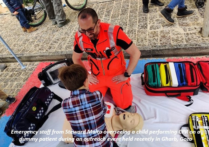 Emergency staff from Steward Malta overseeing a child performing CPR on a dummy patient during an outreach event held recently in Għarb, Gozo