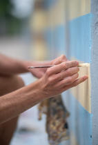 artist painting health care heroes mural