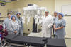 Image of doctor and nurses standing by davinci surgery equipment 