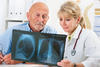 Older man with doc viewing x-ray